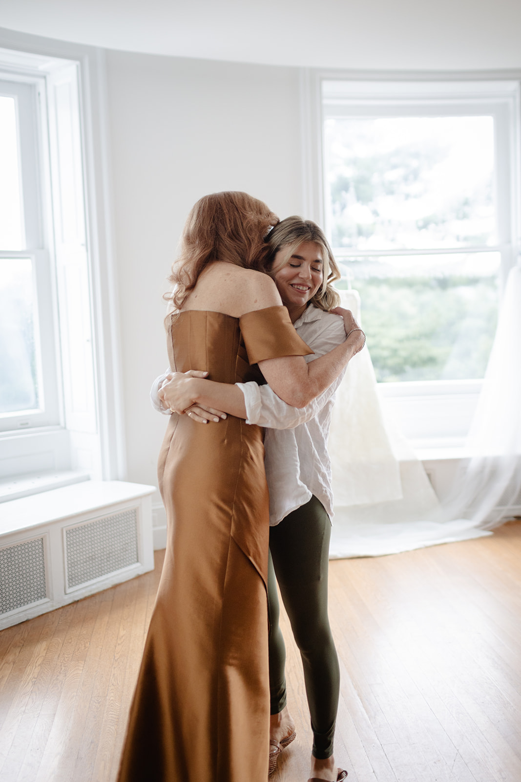 Bride Hugging Mom in Getting Ready Suite of Wave Hill Garden