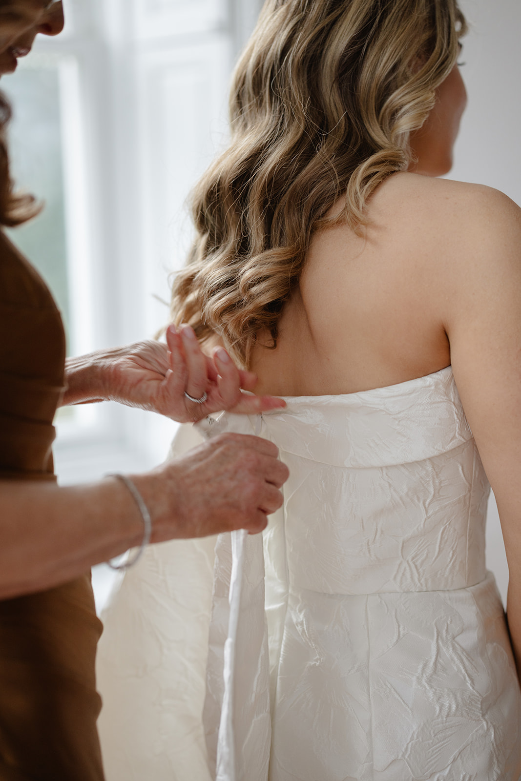 Mom Zipping Bride into Dress for Brooklyn Wedding